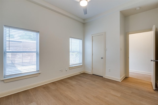 1811 S Ervay St, Dallas, TX 75215 - unfurnished bedroom featuring light wood-style flooring, baseboards, and a ceiling fan