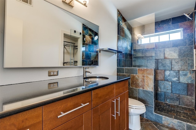 1811 S Ervay St, Dallas, TX 75215 - full bath with a walk in shower, toilet, vanity, and stone finish flooring