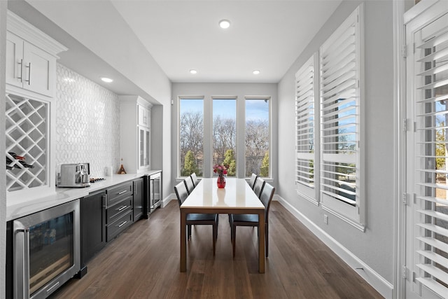15140 Spider Lily Rd, Frisco, TX 75035 - dining space featuring beverage cooler, a bar, baseboards, and recessed lighting