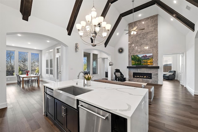 15140 Spider Lily Rd, Frisco, TX 75035 - kitchen featuring arched walkways, dishwasher, a sink, high vaulted ceiling, and open floor plan