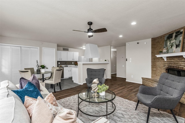 527 Cumberland Dr, Allen, TX 75002 - living room with ceiling fan, dark wood-style flooring, a fireplace, baseboards, and recessed lighting