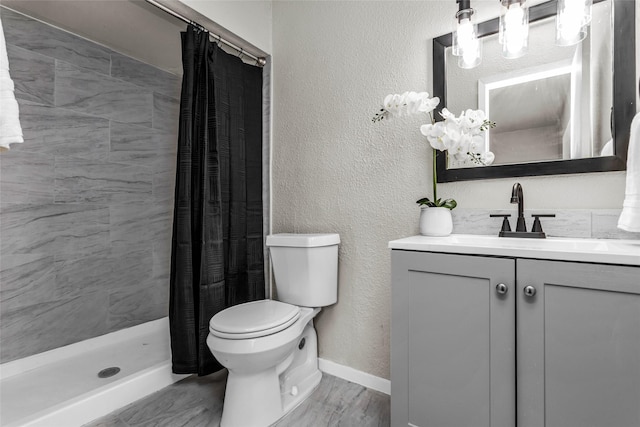 527 Cumberland Dr, Allen, TX 75002 - full bath with toilet, vanity, tiled shower, baseboards, and a textured wall