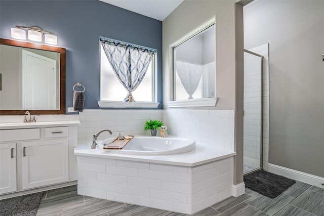 1340 Benavites Dr, Little Elm, TX 75068 - bathroom with vanity, a shower stall, a bath, and wood finished floors