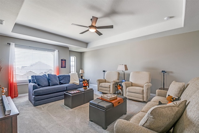 1340 Benavites Dr, Little Elm, TX 75068 - carpeted living area with a tray ceiling, a ceiling fan, and baseboards