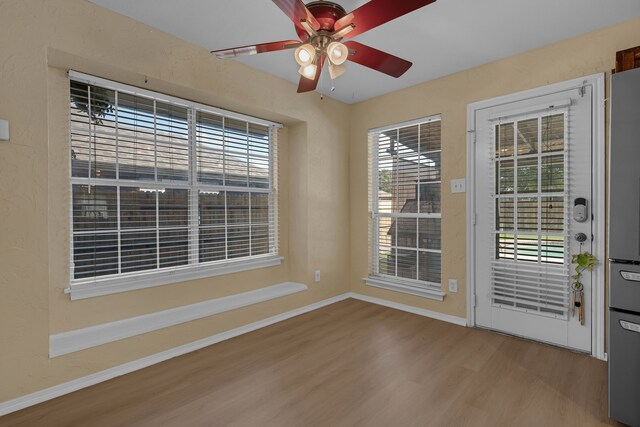 7413 Dana Ln, North Richland Hills, TX 76182 - doorway featuring wood finished floors, plenty of natural light, and baseboards