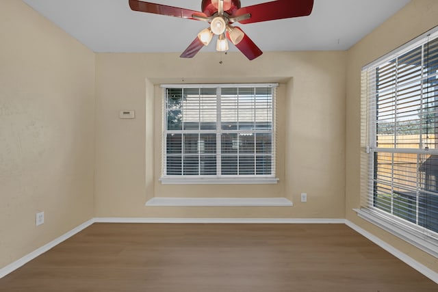 7413 Dana Ln, North Richland Hills, TX 76182 - unfurnished room featuring wood finished floors, plenty of natural light, baseboards, and ceiling fan
