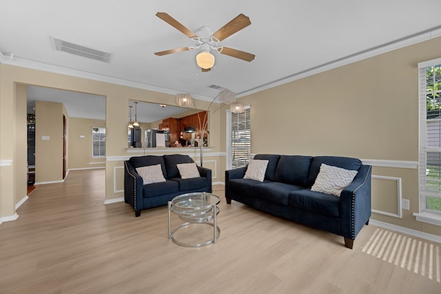 7413 Dana Ln, North Richland Hills, TX 76182 - living area featuring light wood-type flooring, ceiling fan, crown molding, and baseboards
