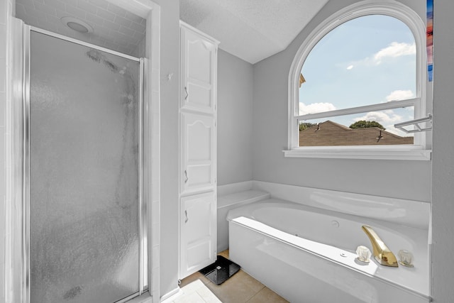 7413 Dana Ln, North Richland Hills, TX 76182 - full bath with a shower stall, a garden tub, tile patterned flooring, and a textured ceiling