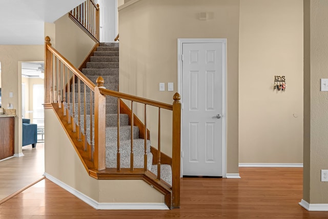7413 Dana Ln, North Richland Hills, TX 76182 - stairs featuring wood finished floors, baseboards, and a ceiling fan