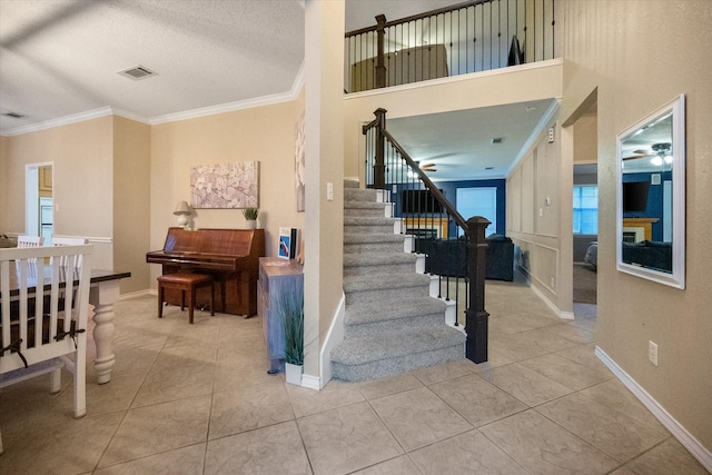 4207 Timber Trail Ct, Arlington, TX 76016 - staircase featuring crown molding, baseboards, tile patterned flooring, a ceiling fan, and a textured ceiling