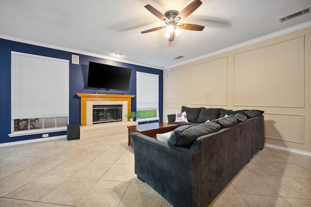 4207 Timber Trail Ct, Arlington, TX 76016 - living area featuring a decorative wall, ornamental molding, a tiled fireplace, ceiling fan, and light tile patterned floors