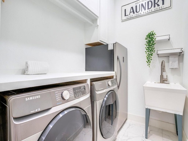 4124 Sandbrock Pkwy, Aubrey, TX 76227 - laundry area with independent washer and dryer, light marble finish floors, baseboards, and cabinet space