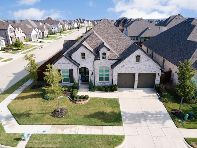 4124 Sandbrock Pkwy, Aubrey, TX 76227 - french country home featuring a residential view, driveway, brick siding, a front yard, and stone siding