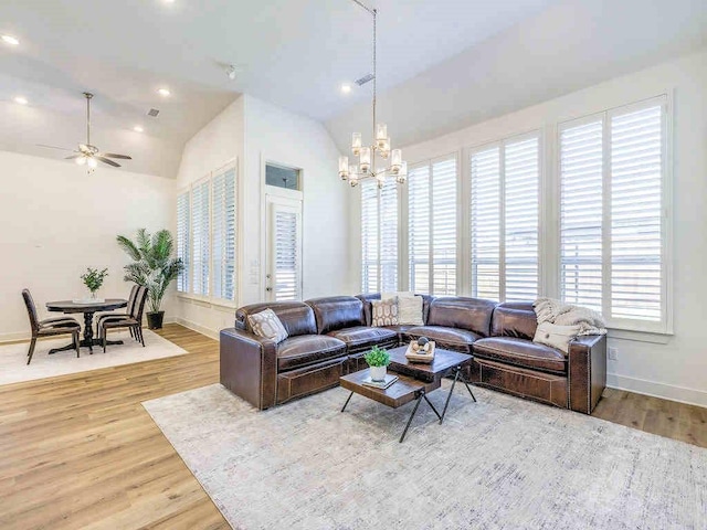 4124 Sandbrock Pkwy, Aubrey, TX 76227 - living room featuring lofted ceiling, wood finished floors, a chandelier, baseboards, and ceiling fan
