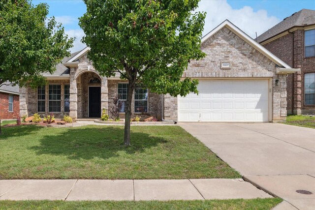 10237 Red Bluff Ln, Fort Worth, TX 76177 - view of front facade with an attached garage, driveway, a front yard, and brick siding
