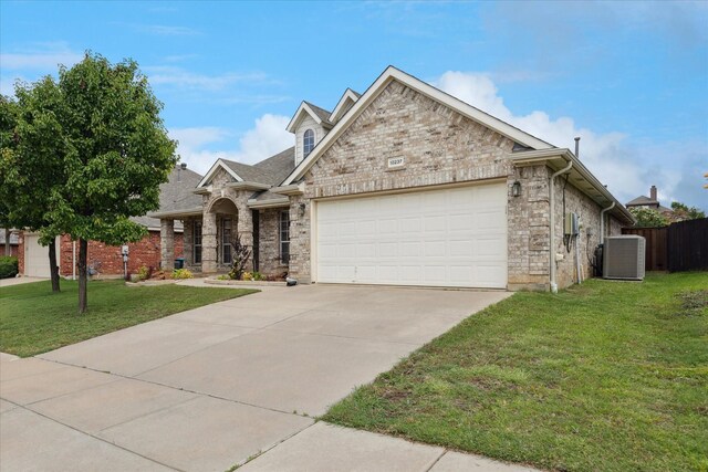 10237 Red Bluff Ln, Fort Worth, TX 76177 - view of front of property with central AC, a garage, concrete driveway, and stone siding