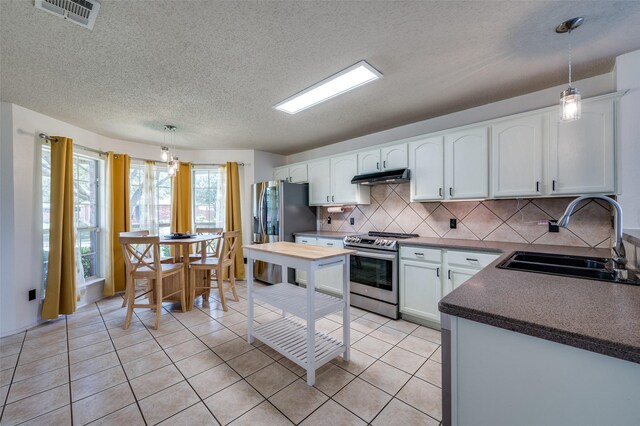 4178 Parterre Dr, Frisco, TX 75033 - kitchen with appliances with stainless steel finishes, a sink, under cabinet range hood, white cabinets, and decorative backsplash