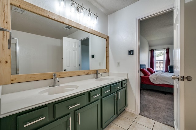 4178 Parterre Dr, Frisco, TX 75033 - bathroom with a textured ceiling, double vanity, tile patterned flooring, and ensuite bathroom