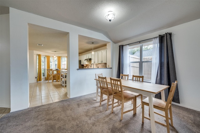 4178 Parterre Dr, Frisco, TX 75033 - dining room featuring lofted ceiling, light carpet, light tile patterned floors, and baseboards