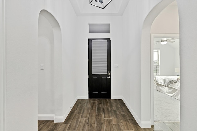 2512 Bunker Hill Dr, Burleson, TX 76028 - foyer entrance featuring arched walkways, dark wood-type flooring, and baseboards