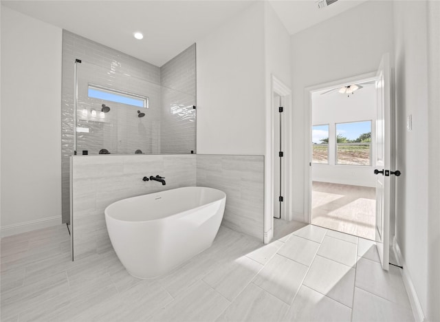 7009 Ranch View Pl, Springtown, TX 76082 - bathroom featuring a walk in shower, a freestanding tub, baseboards, and tile patterned floors