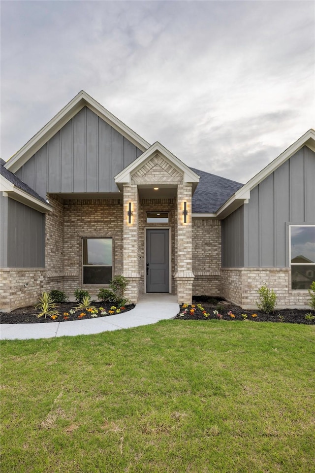 7009 Ranch View Pl, Springtown, TX 76082 - view of front of home featuring board and batten siding, brick siding, a front yard, and a shingled roof