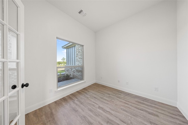 7009 Ranch View Pl, Springtown, TX 76082 - spare room with wood finished floors, baseboards, and vaulted ceiling