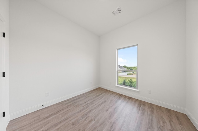 7009 Ranch View Pl, Springtown, TX 76082 - empty room with light wood-type flooring, lofted ceiling, and baseboards