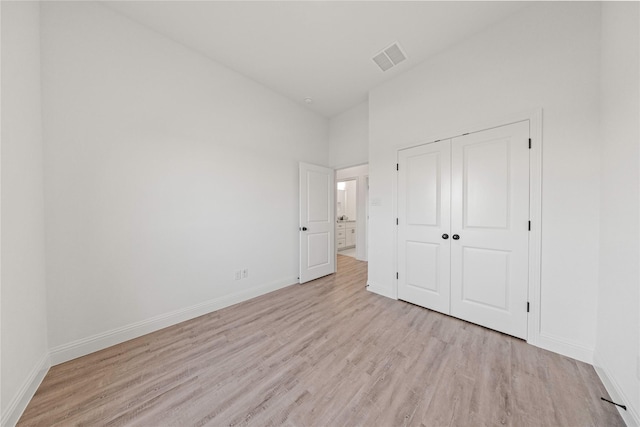 7009 Ranch View Pl, Springtown, TX 76082 - unfurnished bedroom with light wood-style flooring, baseboards, and a closet