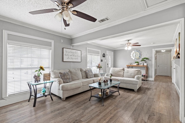 427 Paddy St, Mesquite, TX 75149 - living room featuring light wood-type flooring, a textured ceiling, ceiling fan, baseboards, and ornamental molding