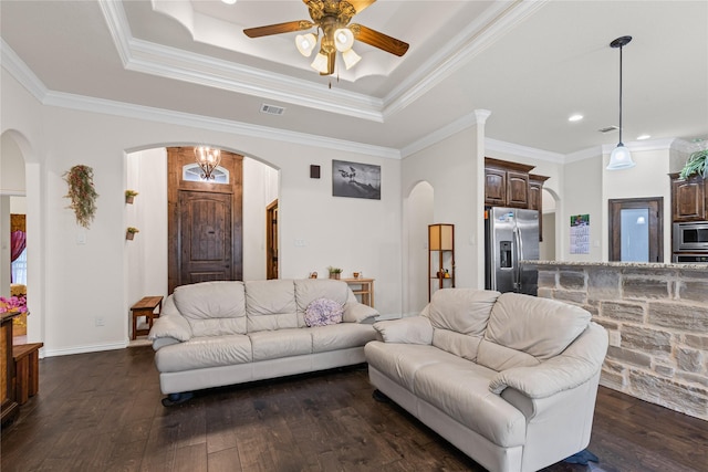136 Spring Meadow Dr, Springtown, TX 76082 - living room with arched walkways, dark wood-style flooring, a ceiling fan, a raised ceiling, and ornamental molding