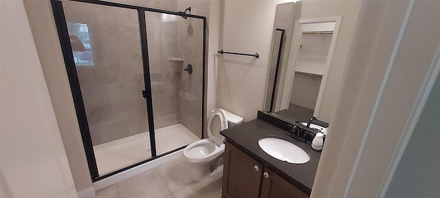 1094 Canterbury Ln, Forney, TX 75126 - bathroom with a stall shower, toilet, vanity, a walk in closet, and tile patterned flooring