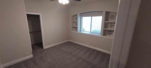 1094 Canterbury Ln, Forney, TX 75126 - unfurnished bedroom with dark carpet, a walk in closet, a closet, arched walkways, and baseboards