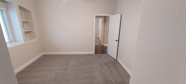 1094 Canterbury Ln, Forney, TX 75126 - unfurnished room featuring carpet, a textured wall, and baseboards