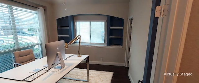 1094 Canterbury Ln, Forney, TX 75126 - home office with plenty of natural light, baseboards, dark wood-style floors, and arched walkways