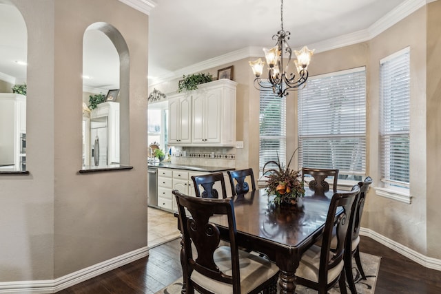 5005 Summerbrook Dr, Colleyville, TX 76034 - dining area with dark wood-type flooring, crown molding, a chandelier, and plenty of natural light