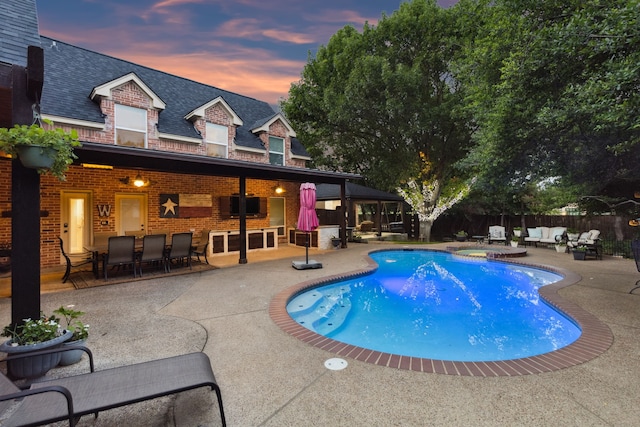 5005 Summerbrook Dr, Colleyville, TX 76034 - pool at dusk featuring a patio area and a pool with connected hot tub