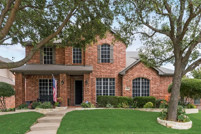 6702 Amesbury Ln, Rowlett, TX 75089 - traditional home with brick siding, a front lawn, and a shingled roof