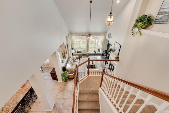 6702 Amesbury Ln, Rowlett, TX 75089 - stairs with a high ceiling, ceiling fan, and tile patterned flooring
