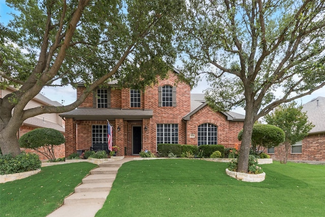 6702 Amesbury Ln, Rowlett, TX 75089 - traditional-style home featuring brick siding and a front yard