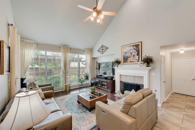 6702 Amesbury Ln, Rowlett, TX 75089 - living room with high vaulted ceiling, a ceiling fan, a tile fireplace, baseboards, and light tile patterned flooring