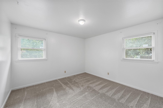 2607 Glendale Dr, Waco, TX 76710 - carpeted empty room with plenty of natural light and baseboards
