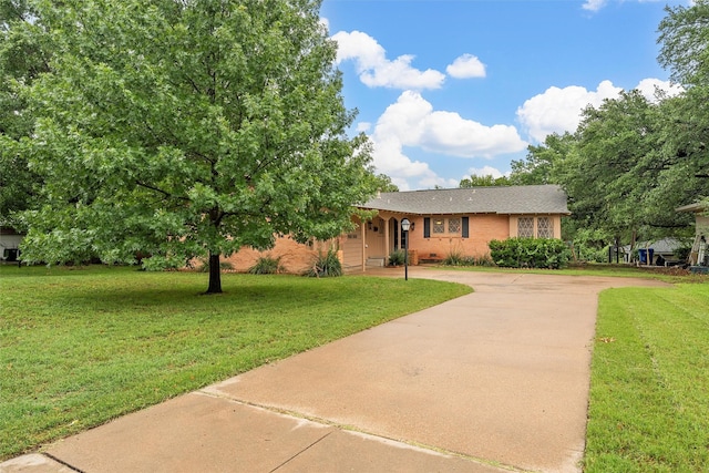 2607 Glendale Dr, Waco, TX 76710 - ranch-style home with concrete driveway, a front yard, and brick siding