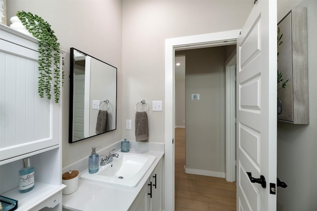 222 Goosewood Dr, Mckinney, TX 75071 - bathroom featuring wood finished floors, vanity, and baseboards
