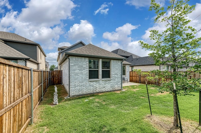 222 Goosewood Dr, Mckinney, TX 75071 - back of house with a shingled roof, brick siding, and a patio