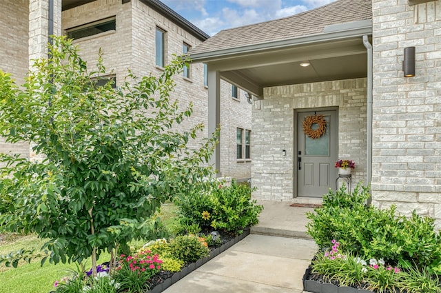 222 Goosewood Dr, Mckinney, TX 75071 - view of exterior entry with brick siding and a shingled roof