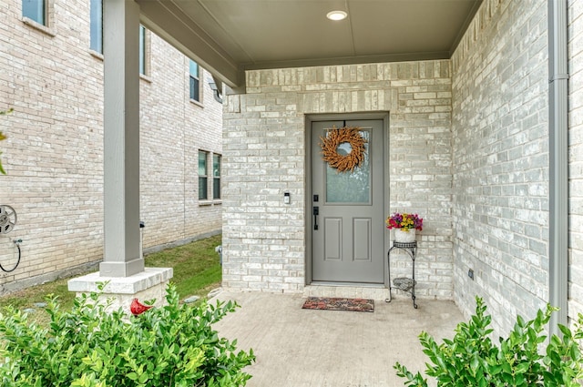 222 Goosewood Dr, Mckinney, TX 75071 - doorway to property with covered porch and brick siding