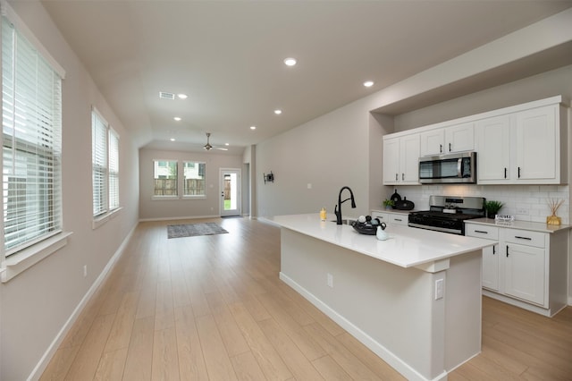 222 Goosewood Dr, Mckinney, TX 75071 - kitchen featuring stainless steel appliances, a sink, tasteful backsplash, light wood-type flooring, and ceiling fan