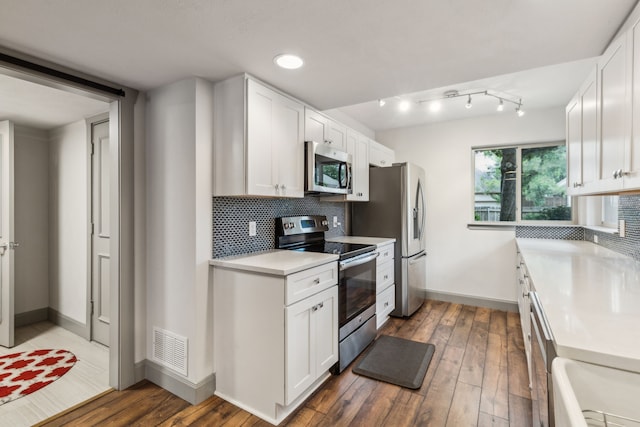 12217 Veronica Rd, Farmers Branch, TX 75234 - kitchen featuring stainless steel appliances, light countertops, wood-type flooring, white cabinetry, and recessed lighting