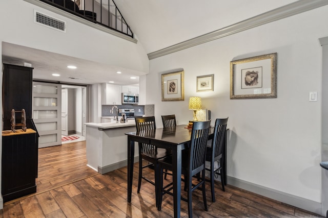 12217 Veronica Rd, Farmers Branch, TX 75234 - dining space featuring dark wood-style floors, baseboards, lofted ceiling, and recessed lighting